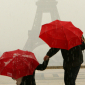 Red Umbrellas at the Eiffel Tower during a hailstorm