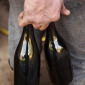 Hands and bottles of a French winemaker